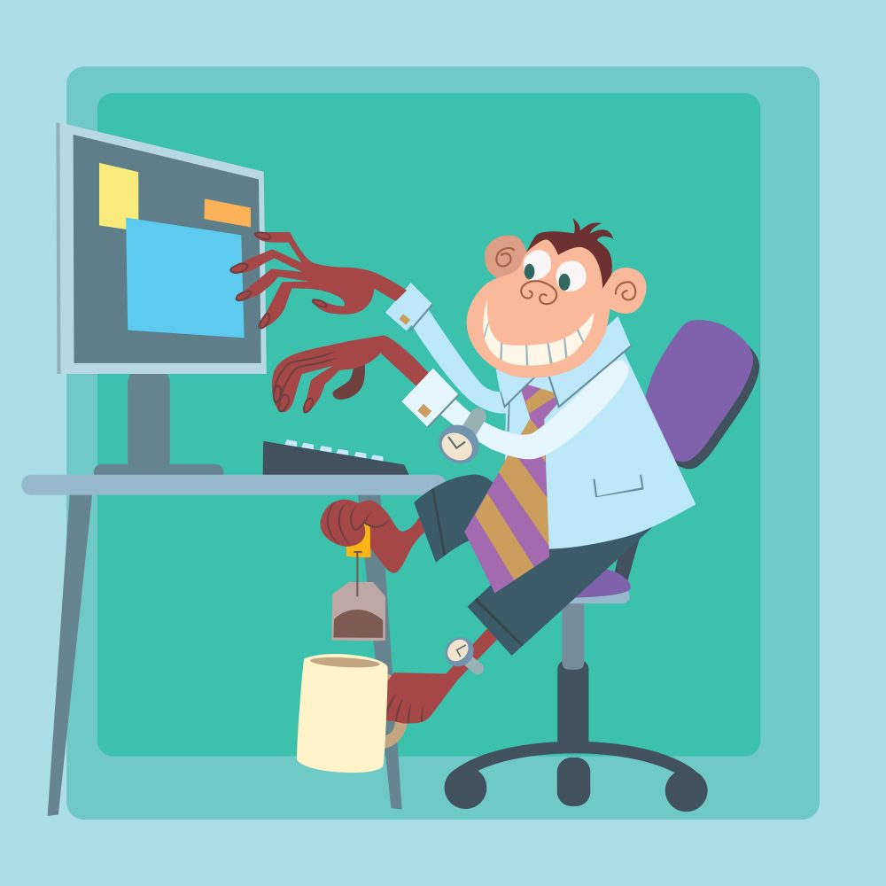 Image of monkey multi-tasking at desk, writing on computer