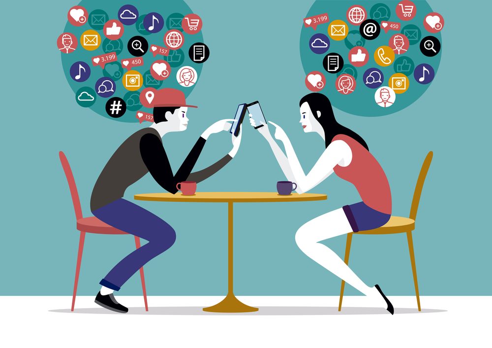 Millennial Couple sitting on a coffee using their smart phones, chatting and texting nessages to friends Networks.